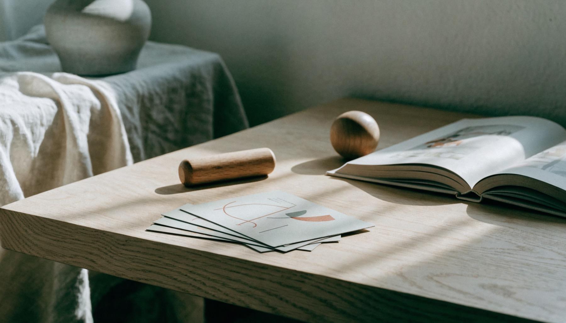 Zolu cards and a picture book on a sunlit wooden table